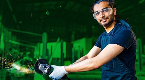 Man met slijptol en veiligheidsbril aan het werk